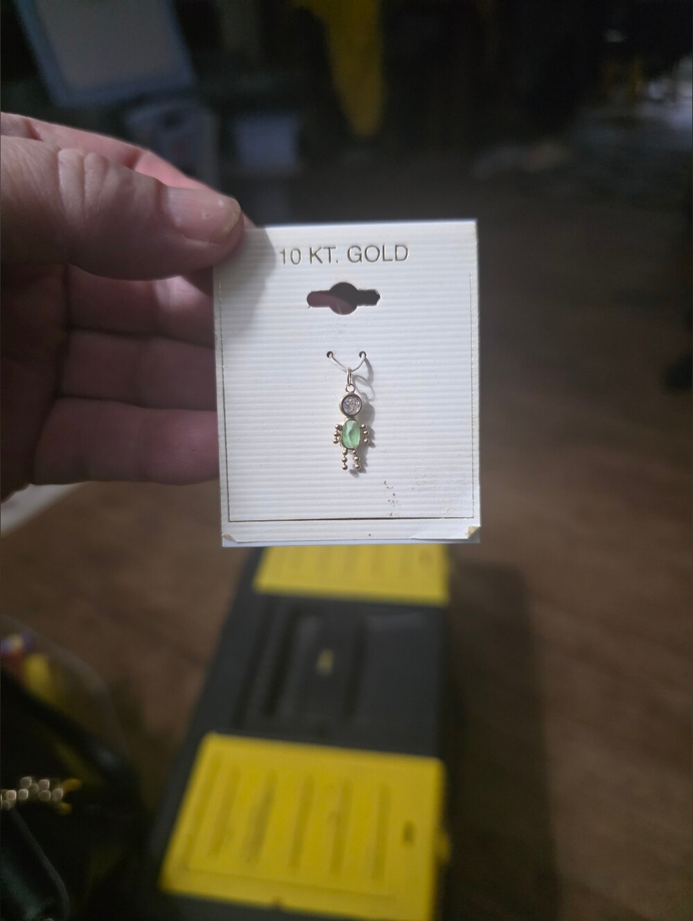 10 KT Gold Child charm on a card